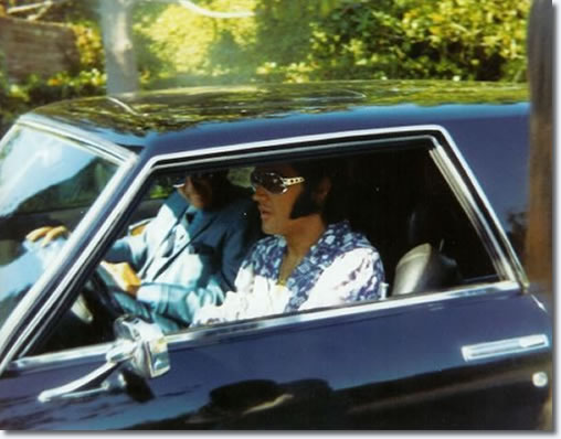 Elvis and John O' Grady leave Elvis' Hillcrest home in his Stutz Blackhawk
